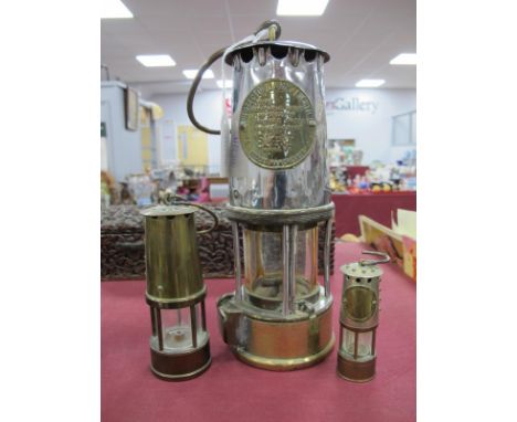 Miners Lamp by Protector Lamp &amp; Lighting Co, 24cm high with handle down; two smaller examples. (3)