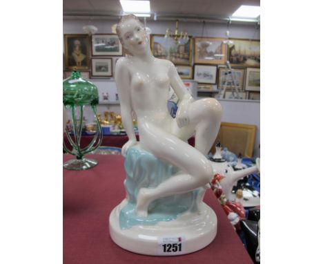 Continental Pottery Figure of a Seated Nude Lady, on blue sheet, circa 1920's wearing yellow wrist band, on oval base, impres