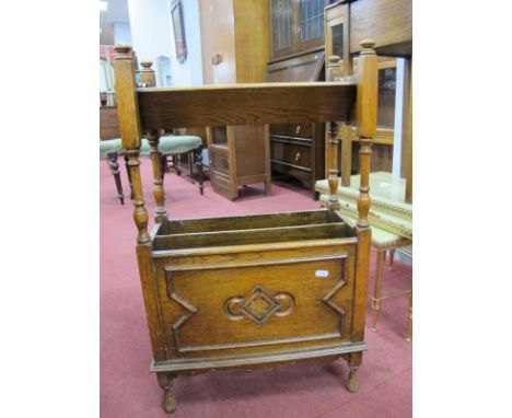 1920's Oak Book Trough, having turned finials, lower magazine compartment featuring Jacobean style carved panel, 43.5cm wide.