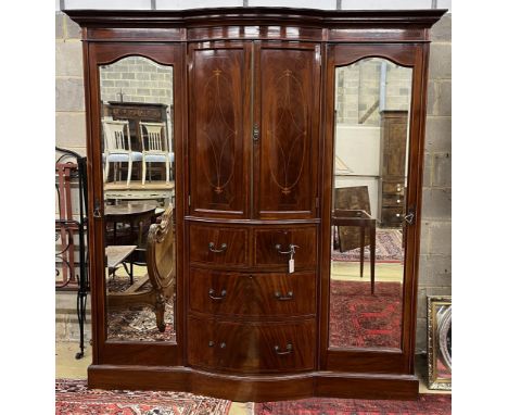 An Edwardian marquetry inlaid and crossbanded mirrored bow front wardrobe, width 196cm, depth 66cm, height 210cm. Condition -
