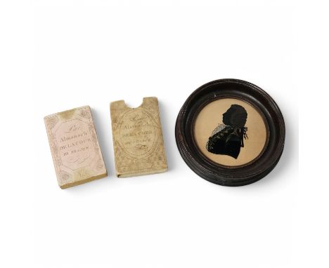 An 1813 Napoleonic Almanack and a reverse glass painted portrait silhouette, 1791, 15cm in diameter. Condition - fair/good