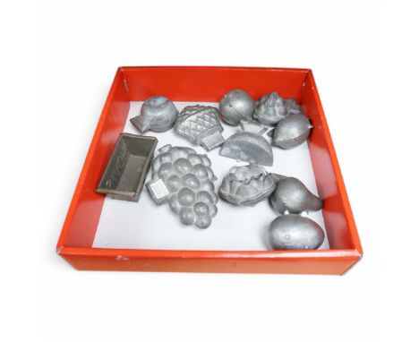 Ten 19th century and later pewter chocolate/ ice cream moulds and a miniature Hovis bread tin. Largest mould 10cm. Condition 
