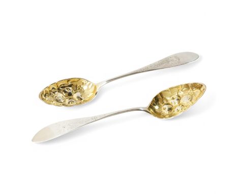 A pair of late 18th/early 19th century German parcel gilt white metal Celtic tip berry spoons, with engraved foliate decorati