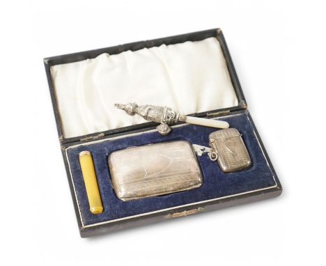 A cased George V three piece smoker's set, comprising a silver cigarette case and vesta case, F.D. Long, Birmingham, 1922 and