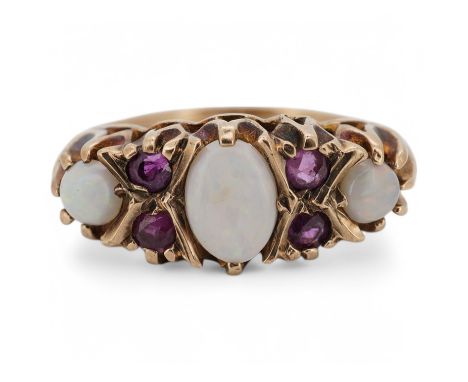 A 9ct, three stone white opal and four stone ruby set half hoop ring, size P, gross weight 4.2 grams. Condition - fair
