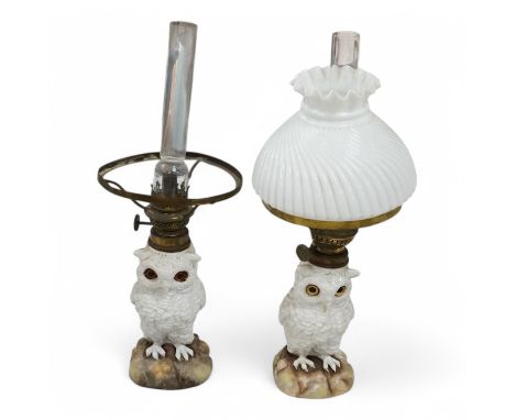 A pair of Paris porcelain oil lamps with white glazed porcelain stems modelled as owls (one lacking shade), 40cm high. Condit
