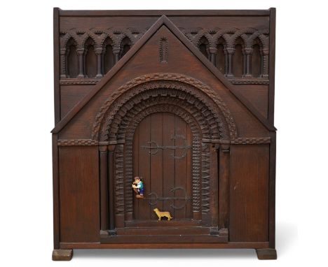 A carved oak firescreen in form of a Norman Romanesque church door and frontage Height 69cm. Width 62cm. Condition - fair