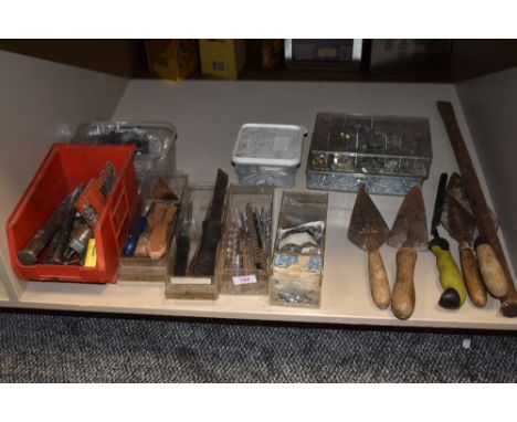 A selection of masonry and similar building tools including trowls and chisels