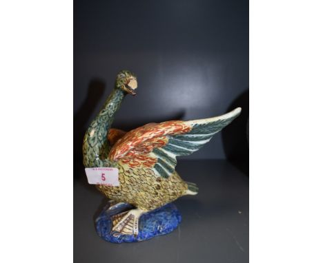 An early ceramic continental figure of a goose or swan possibly Majollica signed 23 to base (damage to beak)