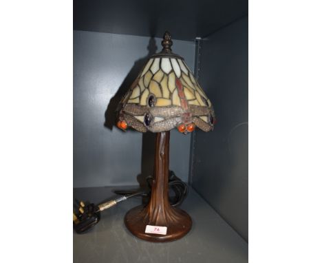 A stained glass Tiffany style desk lamp, having metal tree effect stand.