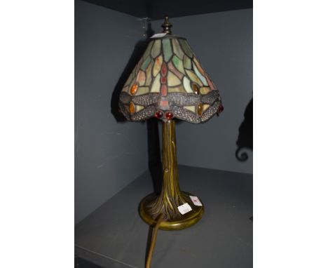 A stained glass Tiffany style desk lamp, having metal tree effect stand.
