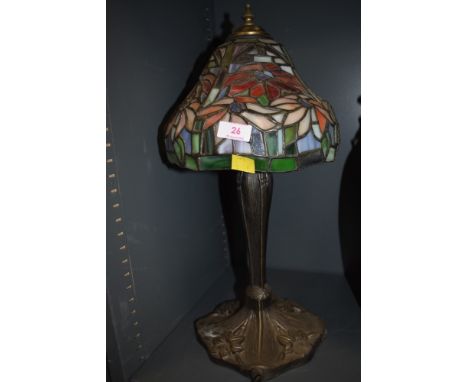 A Tiffany style table top lamp with cast base
