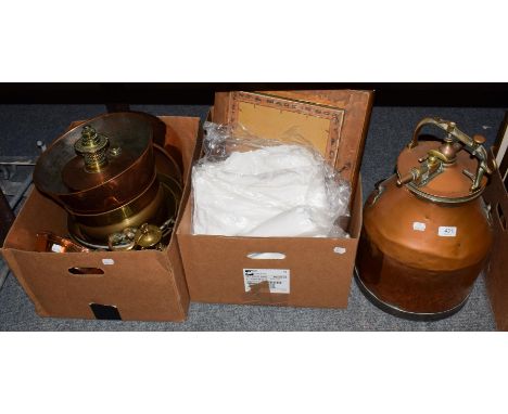 A selection of brass and copper wares comprising a milk churn, brass jam pans, copper dishes, oil lamp, miners lamp, two walk