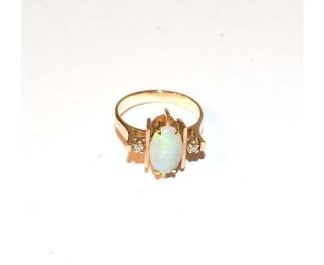 An opal and diamond ring, the central oval cabochon opal flanked by yellow bars to eight-cut diamonds, in yellow claw setting