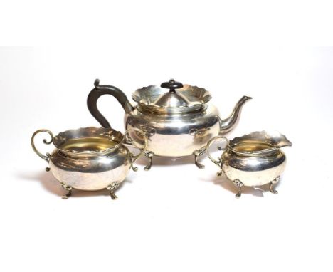 A George V silver tea-service, by Hukin and Heath Ltd., Birmingham, 1919, each piece bombe and on four pad feet, with scroll 