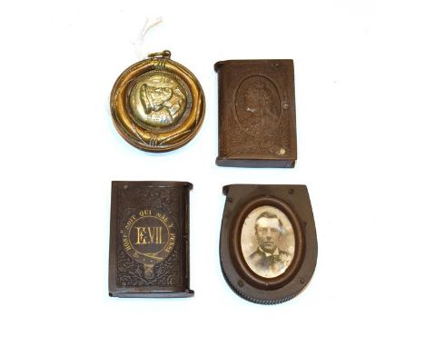 Three Vulcanite vesta-cases, two book shaped, one with the bust of Queen Victoria and the other with Edward VII, the third ho