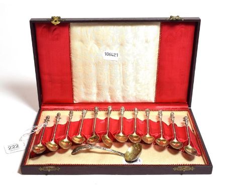 A cased set of twelve gilt-metal coffee spoons, apparently unmarked, circa 1900, each with a classical bust finial in fitted 