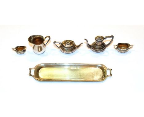 A four-piece Edward VII silver miniature toy tea service, by Adie &amp; Lovekin Ltd, Birmingham, 1906, each piece with fluted