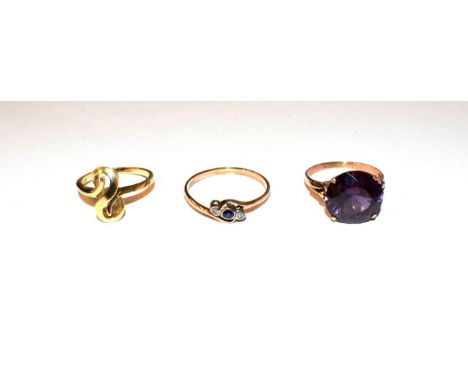 A sapphire and diamond twist ring, stamped '14K', finger size U, a synthetic sapphire ring, stamped '585', finger size R and 