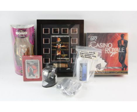James Bond - Skyfall helicopter, shower gel, Corgi playing cards, Bond Girls Honey Ryder, digital watch, and other items. 