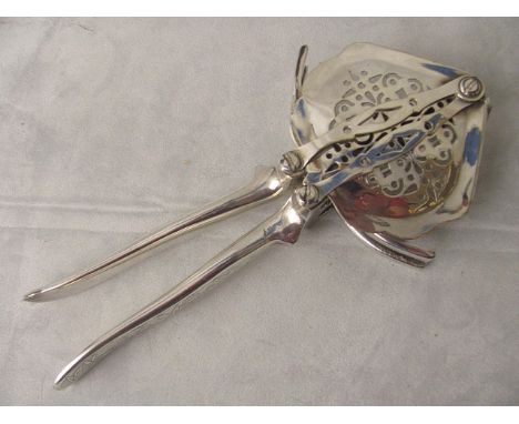 A 19th century Sheffield plated lemon squeezer with pip tray and engraved handles