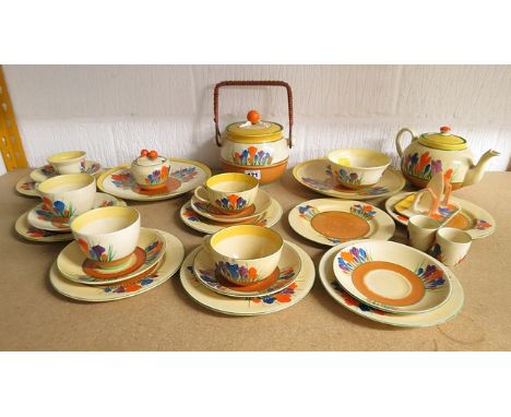 A mixed selection of Clarice Cliff pottery Crocus pattern table wares to include a biscuit barrel and a toast rack (some dama