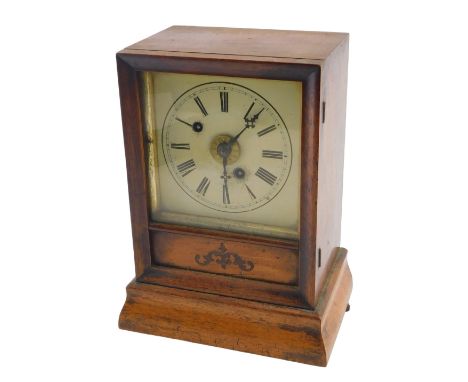 A late 19thC American style shelf clock, with striking movement, painted dial and Roman numerals, bears label to the inside d
