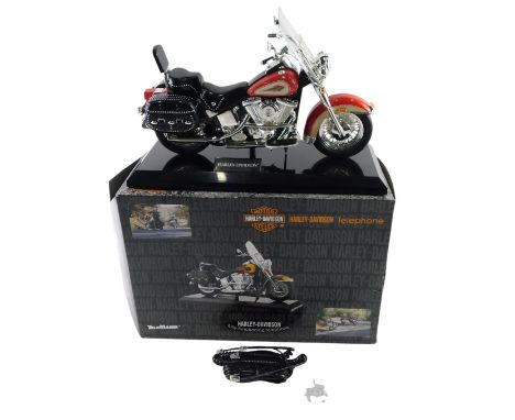 A Tele Mania Harley Davidson model telephone, the red bike boxed.