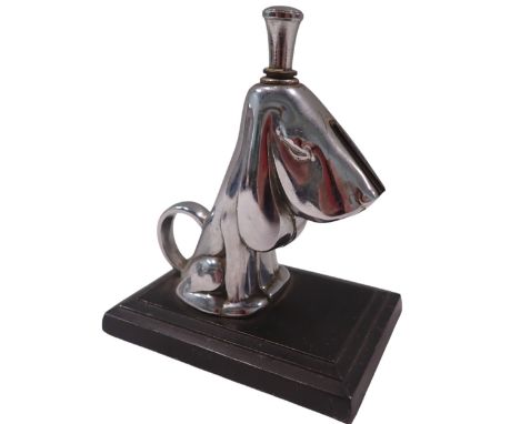 A novelty Ronson table lighter, formed as a dog, on stepped ebonised base, stamped Art Metal Works AMW 1935, 12cm high, 10cm 