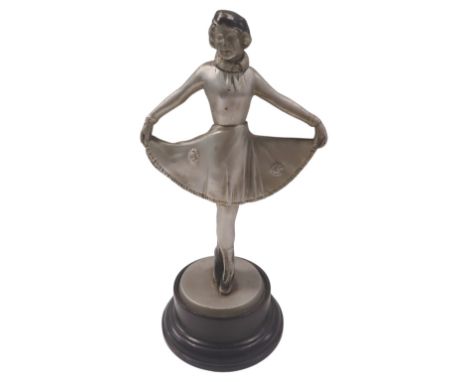 A Sonja Henie Art Deco style table lighter, formed as a lady dancing on a circular and ebonised foot, 30cm high. (AF)