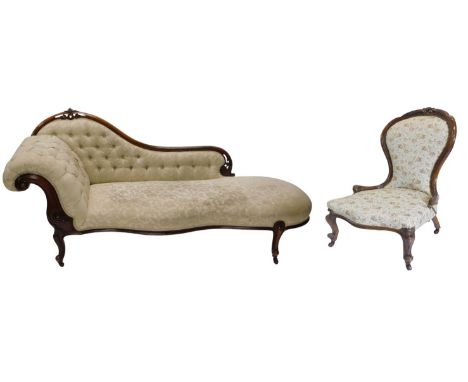 A Victorian walnut framed button upholstered chaise longue, with scrolling carved back and front serpentine front upholstered