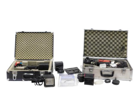 An Olympus VX303 video camera, with accessories in fitted aluminium carry case, and two hand held lighting lamps, in a case.&