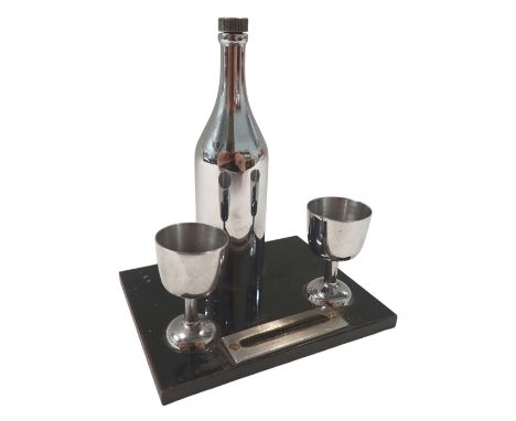 A 1940s/50s table lighter, formed as a bottle of wine and two goblets, central strike, 13cm high, 10cm wide, 7cm deep.