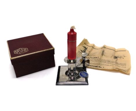 A boxed Kaschie table lighter, formed as a candlestick, in chrome finish on a wooden square set base, with paperwork, 6cm hig