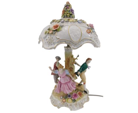 A 20thC German PMP porcelain figural table lamp, the pierced rococo style shade with cameos and encrusted flowers in polychro