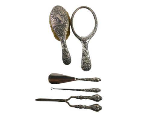 A Victorian and later silver five piece matched dressing table set, comprising mirror and brush, Birmingham 1899, glove stret