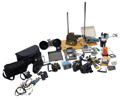 An assortment of video and camera equipment, including two camcorders, a Hanimette slide projector, spot lamps, Aldis project