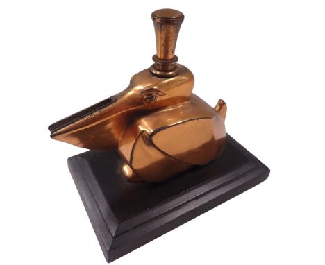 An Art Deco table lighter, in the form of a pelican in bronze finish, on a stepped rectangular base, 9cm high, 10cm wide, 6cm