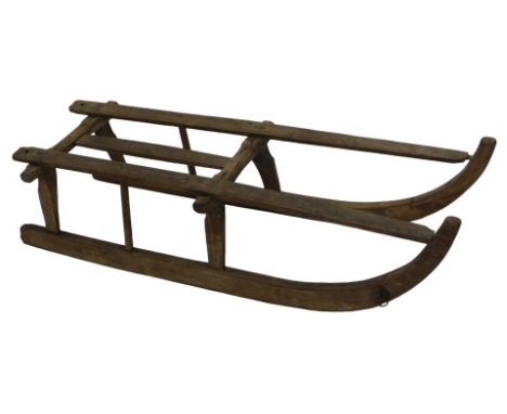 A traditional wooden framed sledge, the runners and work stamped OS, 102cm long.