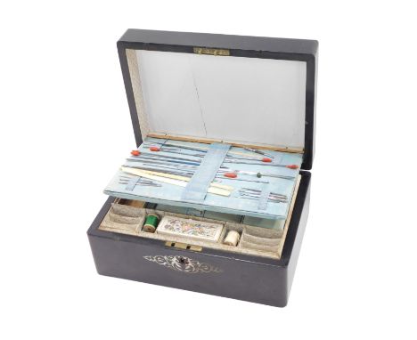 A Victorian ebonised work box, with mother of pearl inlay, the fitted interior with blue silk lining, padding, and papered li