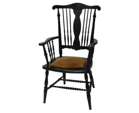 A late Victorian ebonised open arm chair, with spindle back and arm supports, padded seat and bobbin turned stretchers, with 
