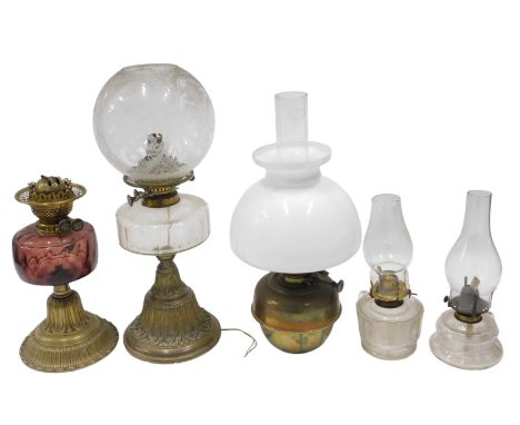 Two Victorian brass table lamps, with Duplex burners, and glass reservoirs, one with an acid etched shade, and fitted for ele