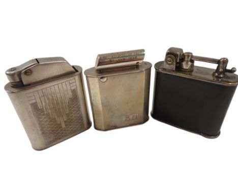 Three table lighters, comprising a Lancel Art Deco black enamel and chrome table lighter, 10cm high, a silver plated lighter 