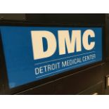 SCOREBOARD SECTION- SIGN "DMC", 51 in. w x 22 in. h ; Located in: SCOREBOARD ***Note from Auctioneer