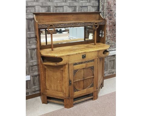 ART & CRAFTS OAK SIDEBOARDthe raised back with open shelf, inset mirror plate below, the pierced enclosing sides with two upr