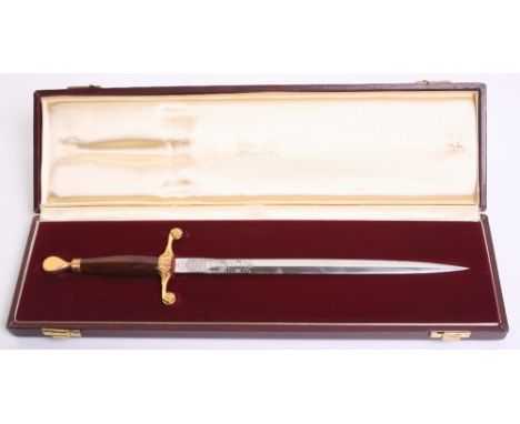 Wilkinson Sword Cased Dagger, having gilt metal top pommel and cross guard, polished wood grip. Blade has panel etched with W