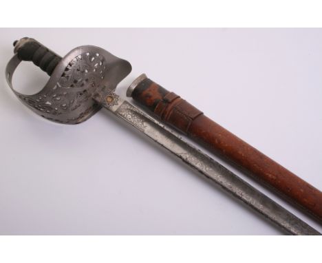 British George V 1897 Pattern Officers Sword complete with its original brown leather field service scabbard. Guard with Geor