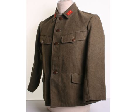 WW2 Japanese Combat Tunic of brown thick wool complete with cloth collar badges. Original tunic buttons (one missing). Lower 