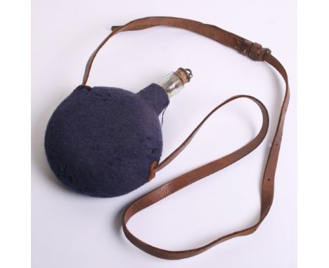 Boer War Period Water Bottle, of glass body with blue felt covering. Complete with its brown leather strap. Some light moth t