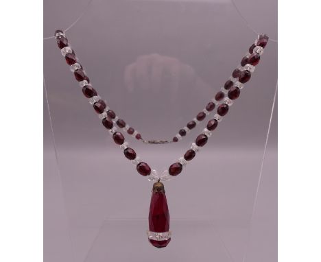 A vintage Czechoslovakian facet cut red and clear glass necklace. Necklace approximately 50 cm long, pendant drop 5 cm high.